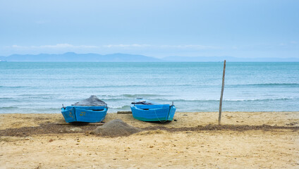 Fototapeta na wymiar Boats on the beach on the coast of Carthage, Mediterranean Sea, Tunisia