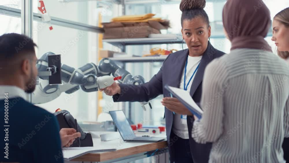 Leinwandbilder Diverse Computer Science Specialists and Black Mentor Looking at Robot Hand and Discussing It while Developing Innovative Programs. Robotics Technologies Concept