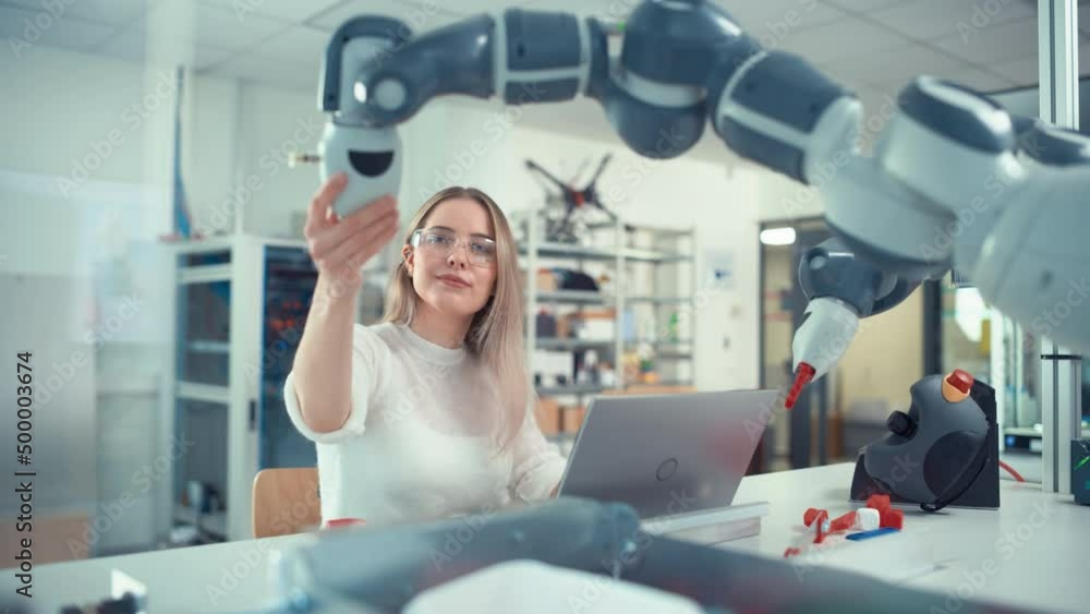 Poster automation female engineer type at laptop and move bionic claw at the factory. modern equipment and 