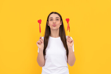 funny lady in white shirt blow kiss with heart on yellow background, womens day