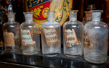 Old bottles of varied liquids for solution