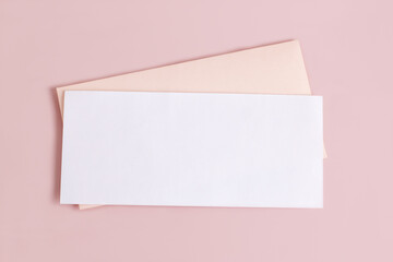 Mockup with a rectangular blank letterhead and an envelope on a pink background.