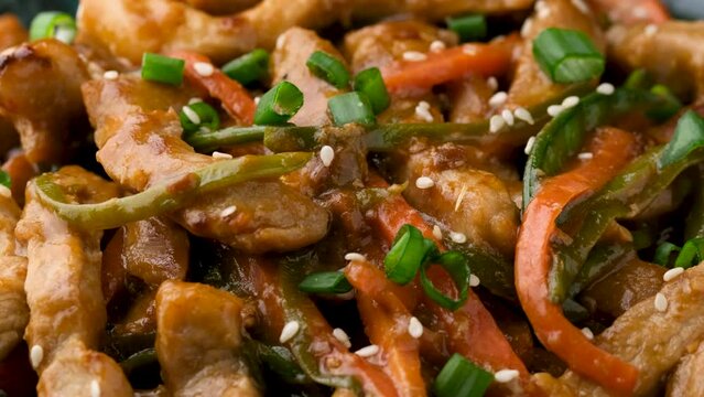 Chinese sichuan shredded pork with vegetables. Asian cuisine. Rotating video