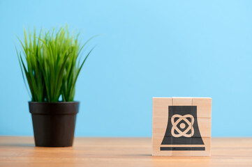 Wooden blocks with symbol of power station energy nuclear plant radioactive electricity reactor...