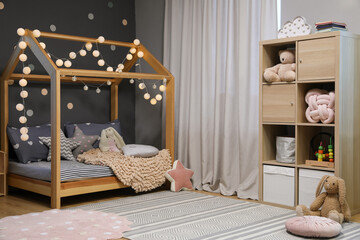 Stylish child room interior with comfortable bed