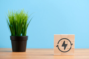 Ecology concept, wooden blocks with icon of conservation eco environment power saving energy solution, on blue background