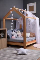 Stylish child room interior with comfortable bed