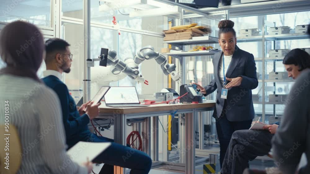Aufkleber Black Specialist Explain to Diverse Computer Science Specialists While Robot Limb Moving Under her Controlling. People Designing Automated Robotic Systems Concept