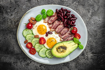 Ketogenic diet meal avocado, fried eggs, bacon, and beans. Healthy nutritious paleo keto breakfast diet lunch. banner, catering menu recipe place for text, top view