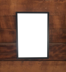 Empty picture frame mounted on an old wooden wall