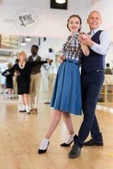 Happy man and woman enjoying ballroom dancing