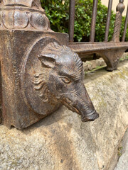 Fototapeta na wymiar Palermo, Sicily. April 15, 2019. Head of a Pig cast in iron and part of the fencing of the Giardino Garibaldi in Palermo.