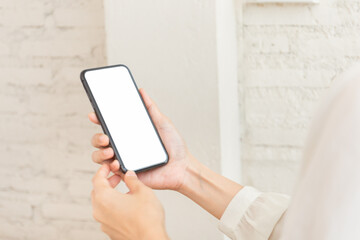 cell phone blank white screen mockup.hand holding texting using mobile on desk at office.background empty space for advertise.work people contact marketing business,technology