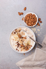 Healthy breakfast of granola with fresh banana, nuts and yogurt