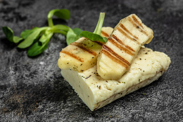 grilled slices of halloumi cheese with grill marks and mint. Cyprus squeaky cheese. Food recipe background. Close up
