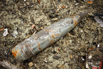 Close-up of artillery shell on the ground