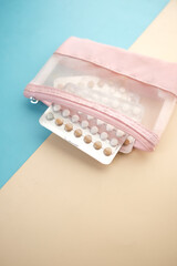 birth control pills on wooden background, close up 