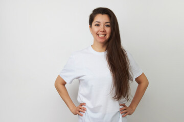 Fototapeta premium Smiling woman pointing up on white background