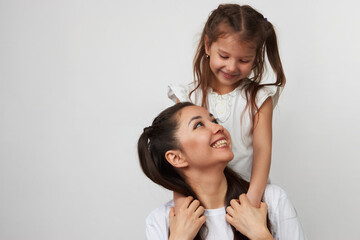 Happy woman and child girl 5-6 years old having fun