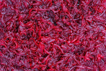 Background and texture of raw fresh grated red beetroot vegetable