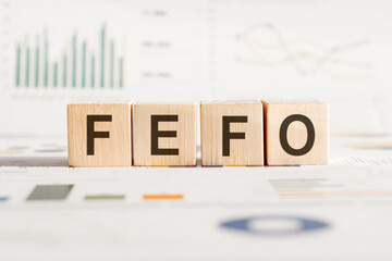 The word FEFO - abbreviation of first expired first out on wooden cubes