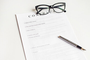 Fototapeta premium White table with paper contract detail. Business concept