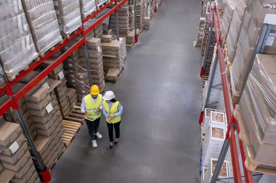 Manager and worker at warehouse, above view. Logistics center