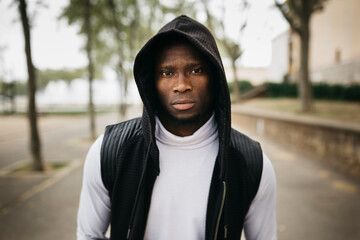 Portrait of a hooded young black male on the street