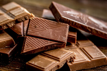 black chocolate close up on wooden background