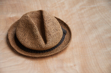 Travelling brown hat on wooden desk. Copy space and travelling concept