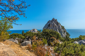 Rock Diva on beach, beautiful black sea shore landscape with mountain cliff, main nature landmark...