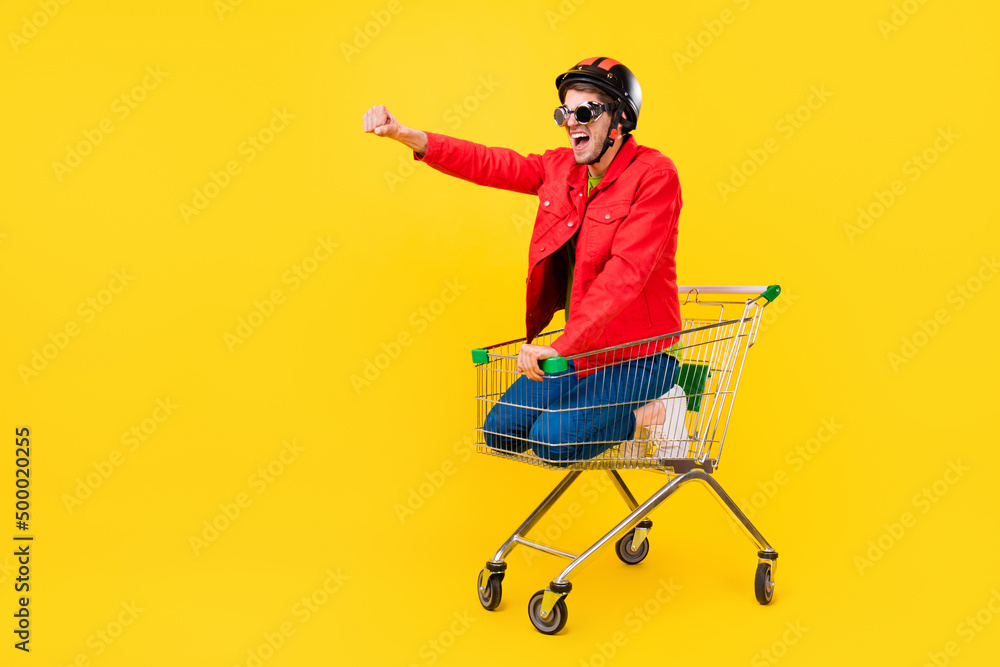 Poster Full length body size view of attractive cheery guy inside cart having fun riding fooling isolated on bright yellow color background