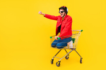 Full length body size view of attractive cheery guy inside cart having fun riding fooling isolated...
