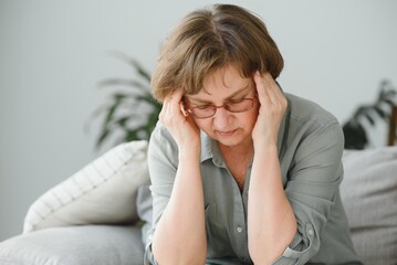 health care, pain, stress, age and people concept - face of senior woman suffering from headache - obrazy, fototapety, plakaty
