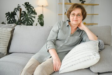 Closeup portrait of older woman wearing glasses.