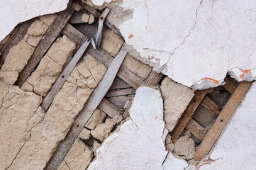 Fragment of the destroyed wall of an old house. Ancient construction technologies. Concrete and...
