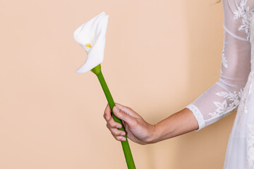 Unrecognizable bride with Zantedeschia flower