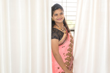 Happy young beautiful Indian woman in saree.