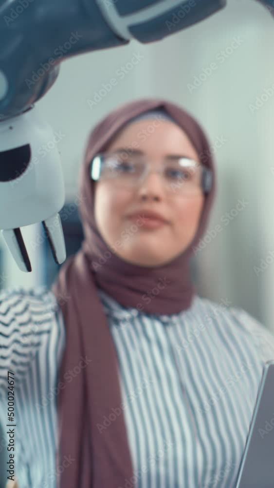 Poster portrait of muslim businesswoman wearing hijab works on engineering project, coding at laptop and ch