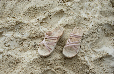 Fototapeta na wymiar female tourist shoes removed at the sandy beach