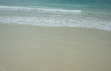 Fototapeta na wymiar Sea waves blowing on the beautiful sandy beach.