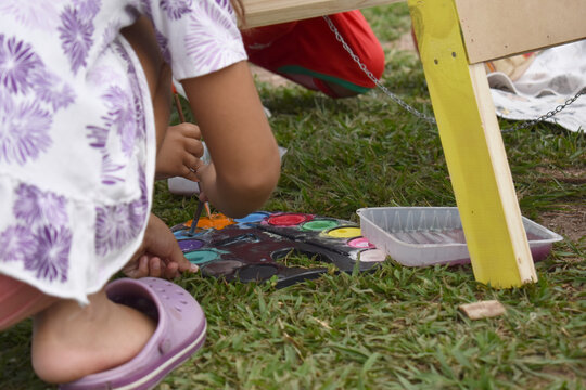 children paint outdoors in nature