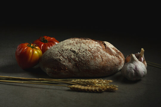 Bread near tomatoes and garlic