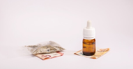 oil cannabis bottle and bag plastic, money. The concept of selling marijuana, hemp and drugs