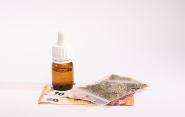 oil cannabis bottle and bag plastic, money. The concept of selling marijuana, hemp and drugs