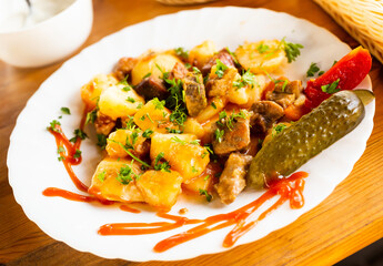 traditionally Russian dish of stewed potatoes with meat. Zharkoe po domashnemu