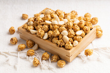 Caramel popcorn with macadamia nut in bamboo wooden box