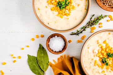 Top view of corn chowder soup on the decorated white wooden table - obrazy, fototapety, plakaty