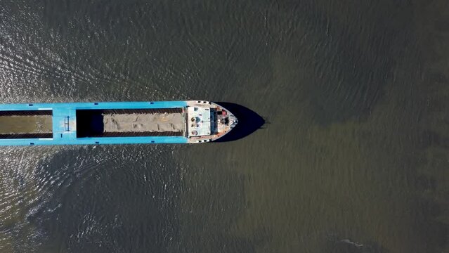 Dredging ship sails trhough the fairway, river IJssel in the Netherlands, Aerial  