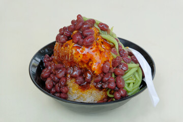 Cendol, a sweet dessert made with shaved ice and green rice flour jelly, coconut milk, syrup topping